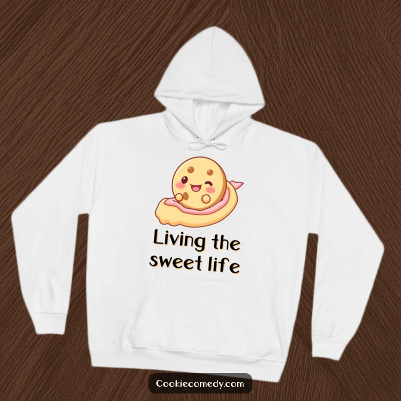 Funny hoodie featuring a cookie character delightedly tobogganing down a smooth ribbon of frosting, offering comfort and cheer.